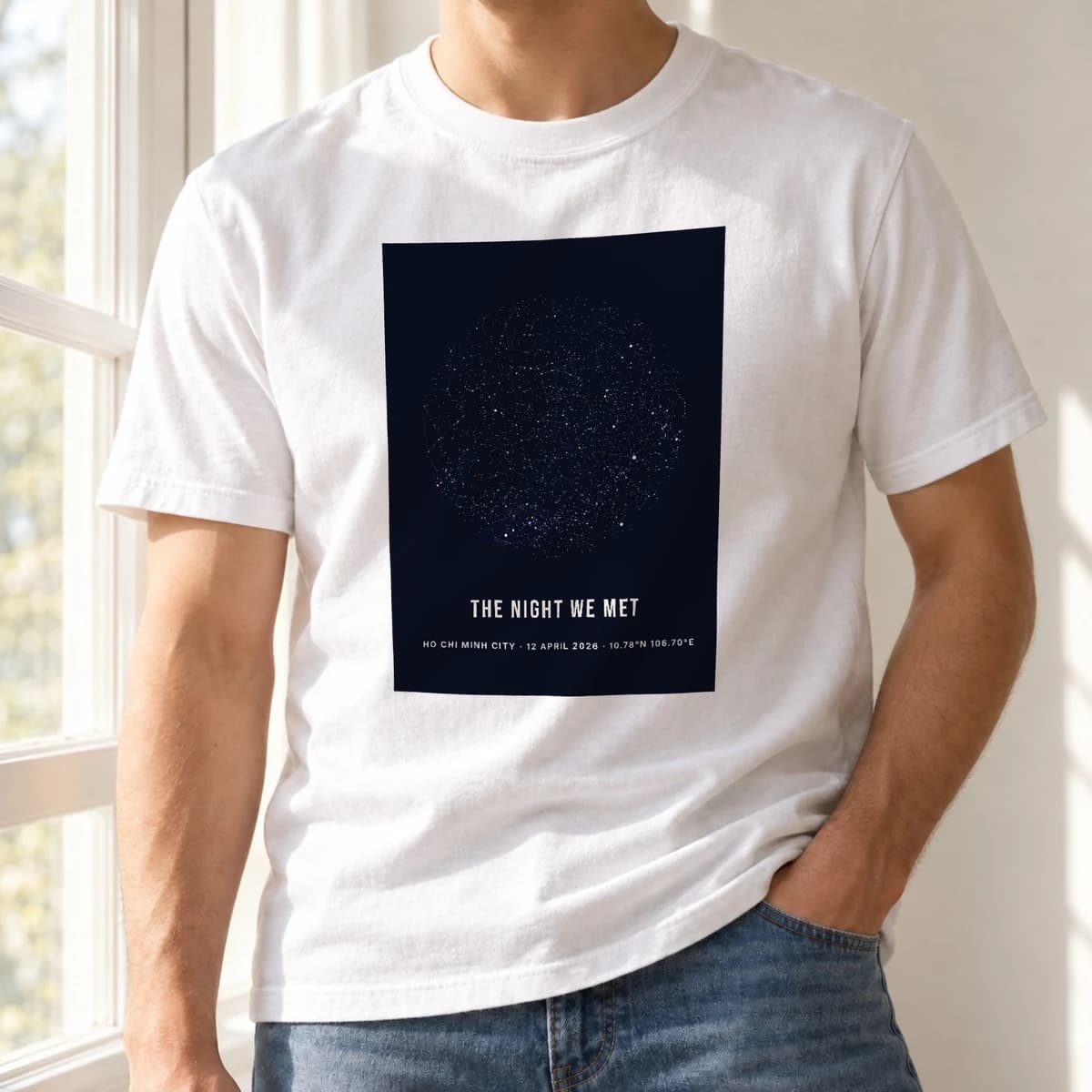 The same worn white tee with a navy star-map print on the chest, captioned The Night We Met, rendered by the runtime onto the photo