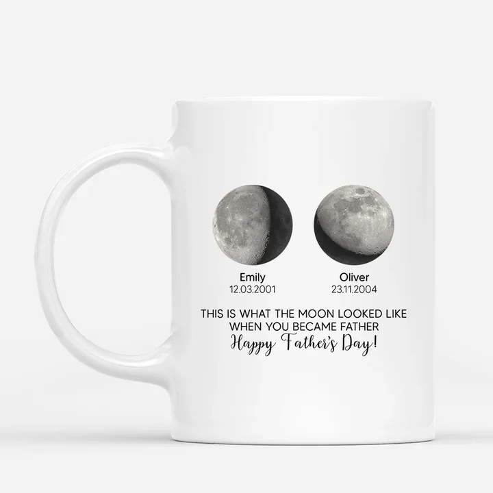 A white mug printed with two moon phases, each labelled with a name and a date, under the line This is what the moon looked like when you became father