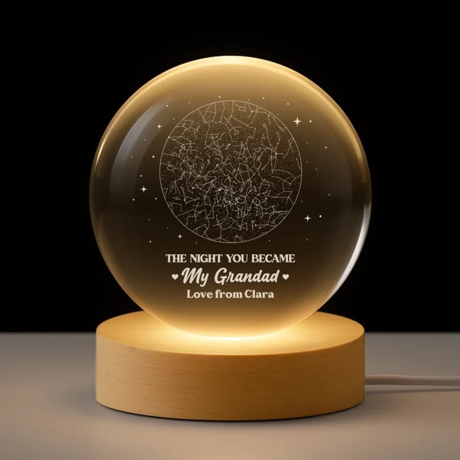 A round engraved crystal light on a wooden base, lit warm, showing a night sky above the words The Night You Became My Grandad